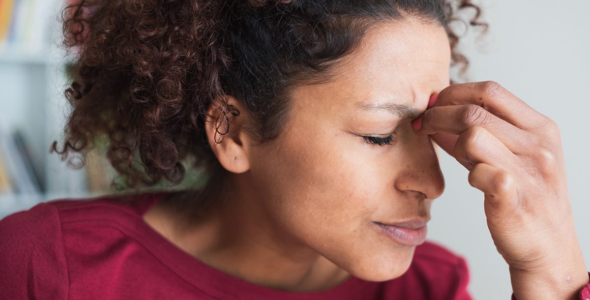 A woman experiencing symptoms and signs of a stroke