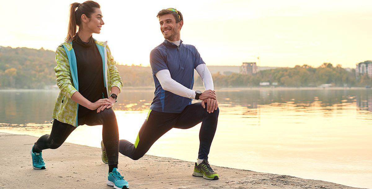 Two people stretching before a run.