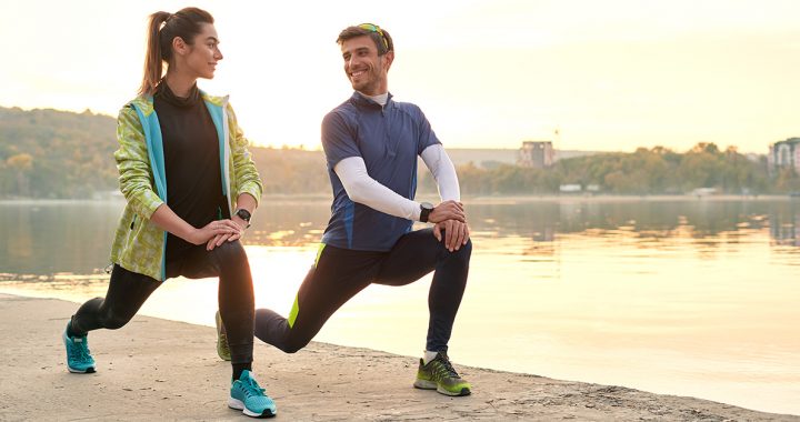 Two people stretching before a run.