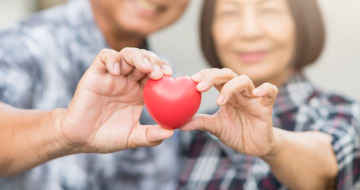 man and woman holding a heart - TAVR