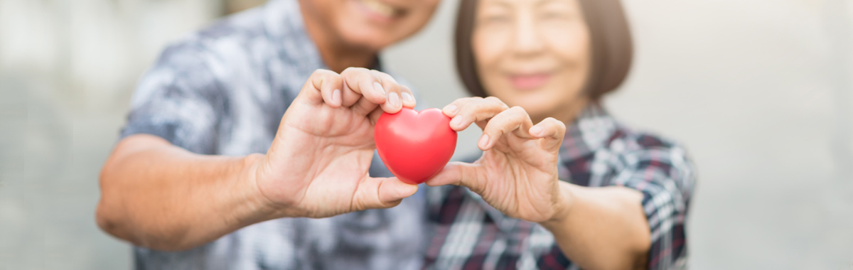 man and woman holding a heart - TAVR