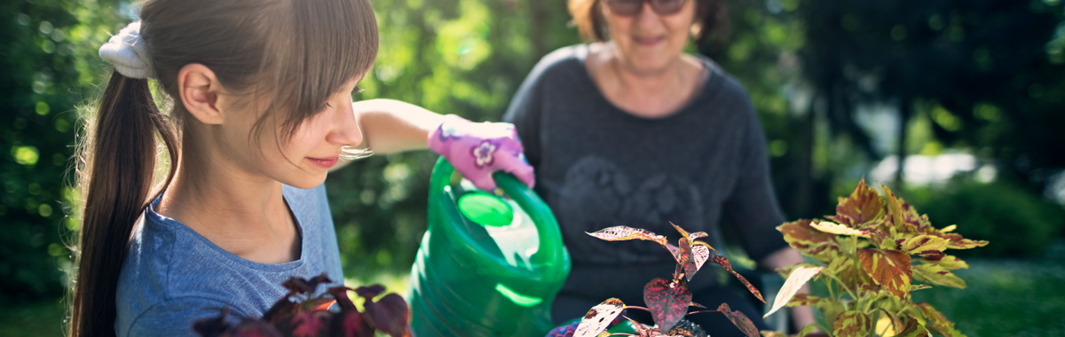 daughter gardens with her mother _ how to adjust kids summer schedules