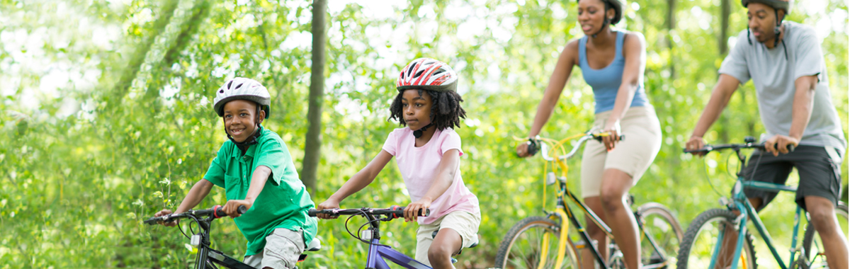 african-american family bike riding together - bike safety tips from mercy health