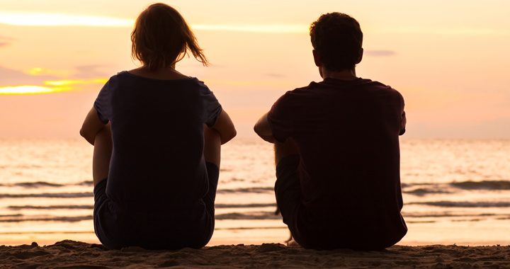 man and woman watch the sunrise on a beach_ how to practice mindfulness