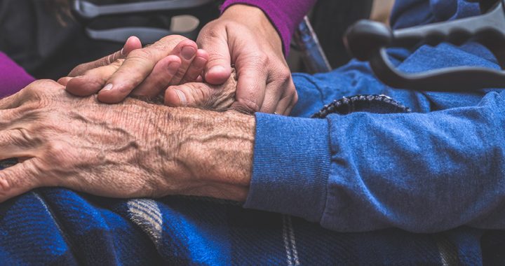 man and woman hold hands _ parkinsons disease