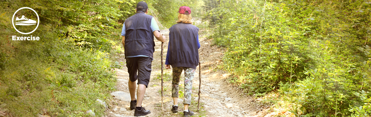 man and woman hike in nature _ benefits of walking