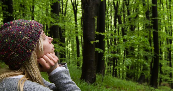 woman takes a deep breath in the forest _ nature baths and their benefits