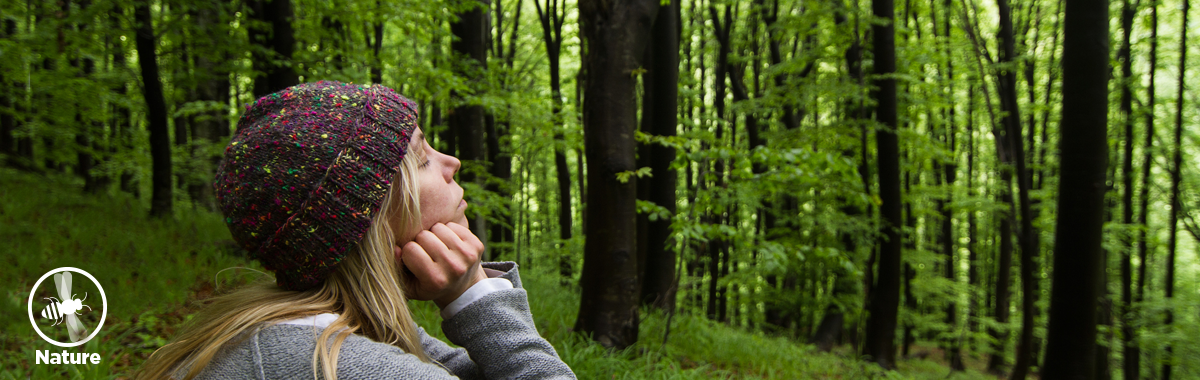 woman takes a deep breath in the forest _ nature baths and their benefits