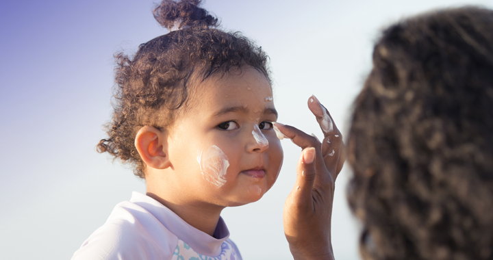 mom applies sunscreen on daughters face _ best ways to prevent skin cancer from mercy health