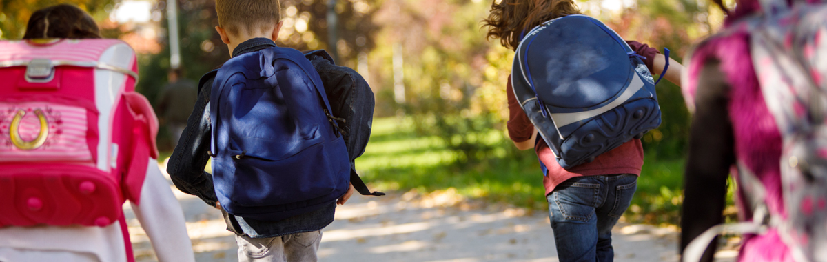 two kids walk with their backpacks _ backpack health tips mercy health