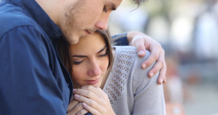 A person comforting a loved one while discussing suicide.