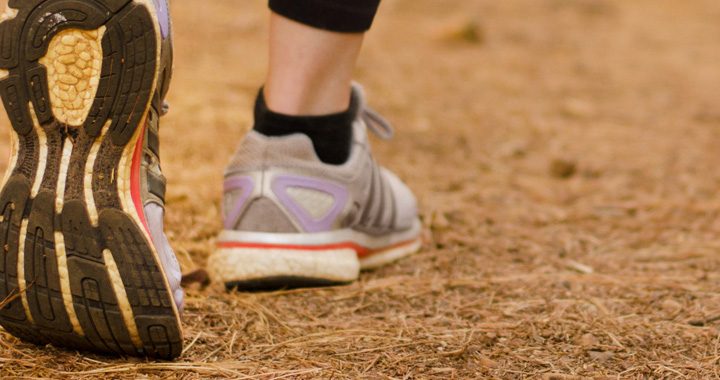 View of person's gymshoes walking away - walking strides