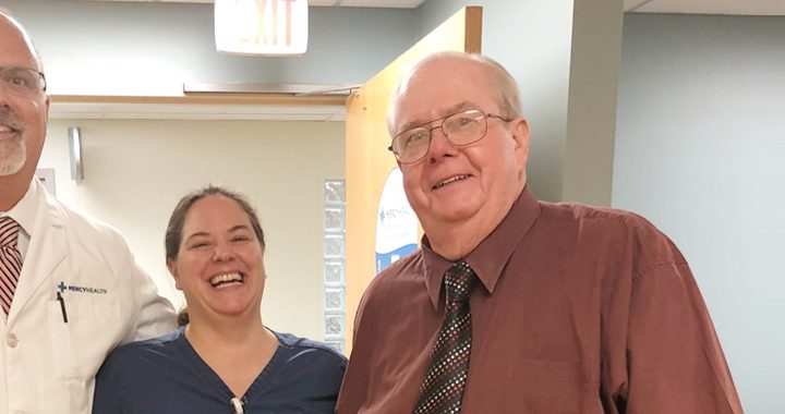 male patient and two members of his health care team smile after successful treatment of cellulitis