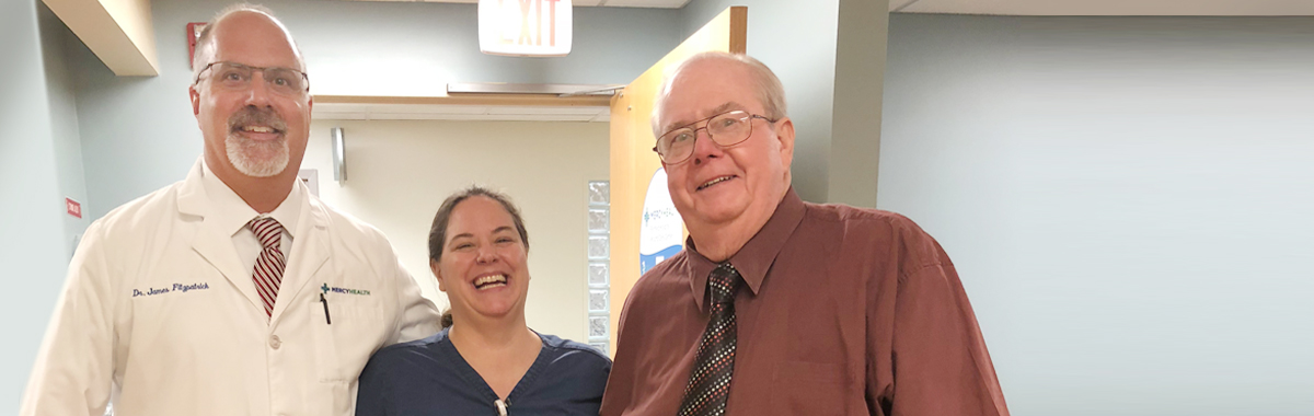 male patient and two members of his health care team smile after successful treatment of cellulitis