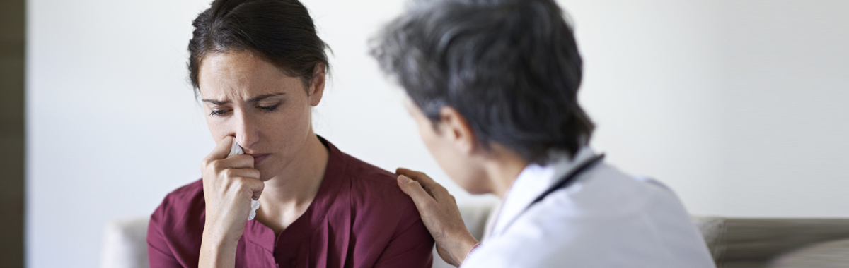 Female physician counseling patient on anxiety and stress