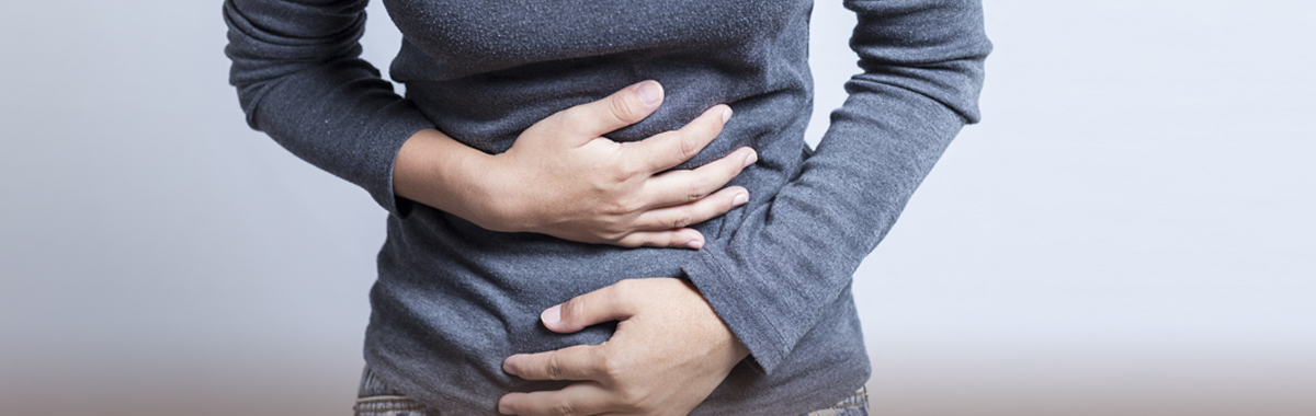 Woman with Crohn's disease holding stomach