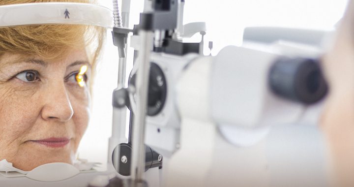 Woman having eye health checked by getting eye exam