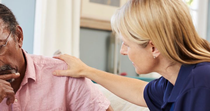 woman laying her hand a man's shoulder while counseling him for bipolar disorder