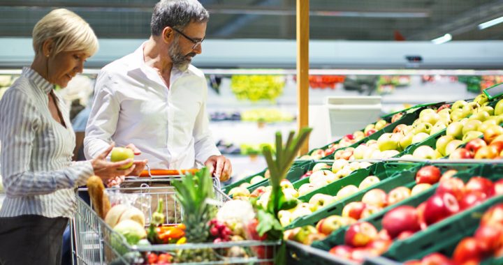 couple looking at produce section of the grocery store