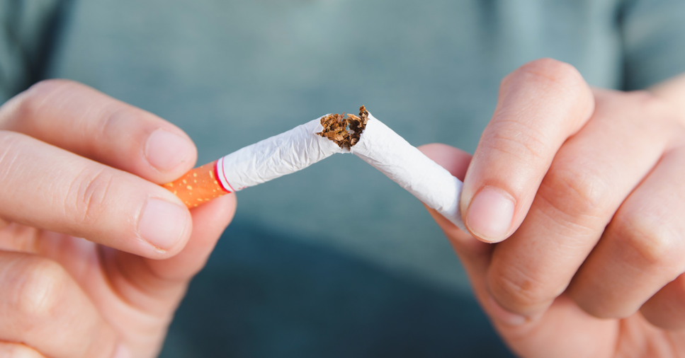 image of hands snapping a cigarette in half