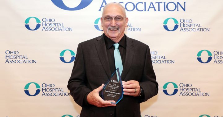 Dennis Hanlon, BSN, RN, EMSI, Paramedic, a shift supervisor in nursing administration at Mercy Health – Willard Hospital, holds his award for being the OHA Health Care Worker of the Year