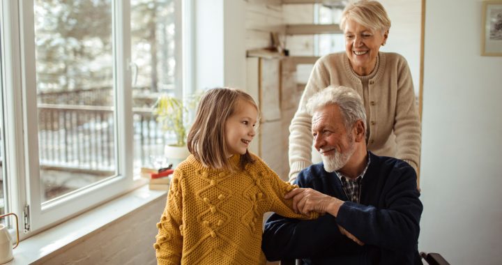 Grandmother, grandfather and granddaughter inside their house.