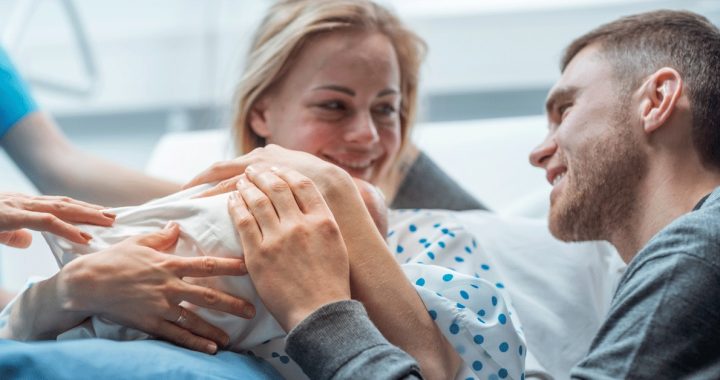 Childbirth moment in a hospital settings with a baby and parents