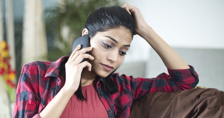 Woman advocating for a loved one by staying in touch with hospital staff via phone