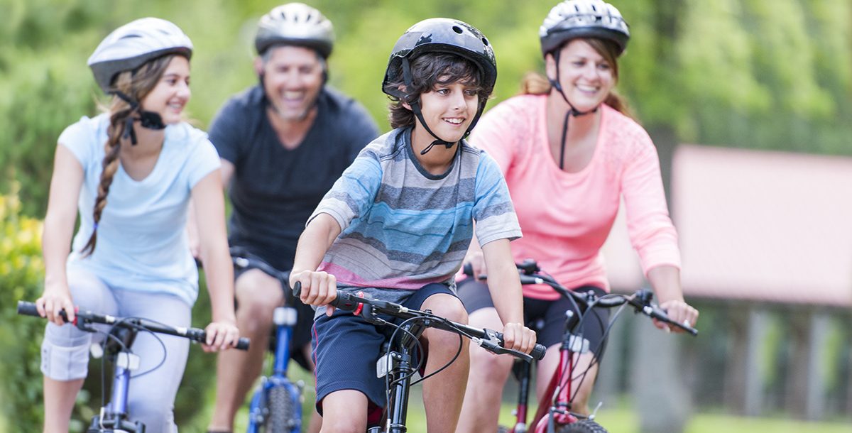 family riding bikes in their neighborhood together