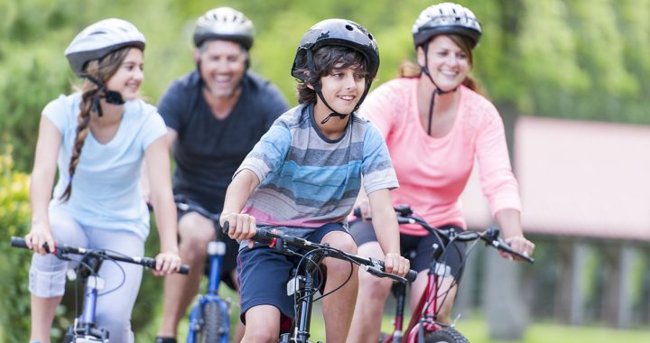 family riding bikes in their neighborhood together