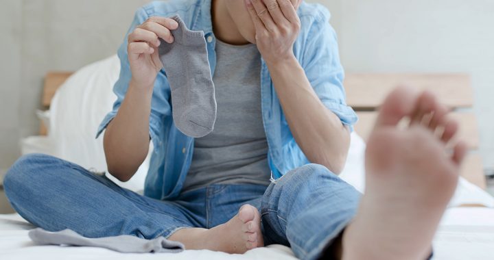 A person taking a look at their athlete's foot.