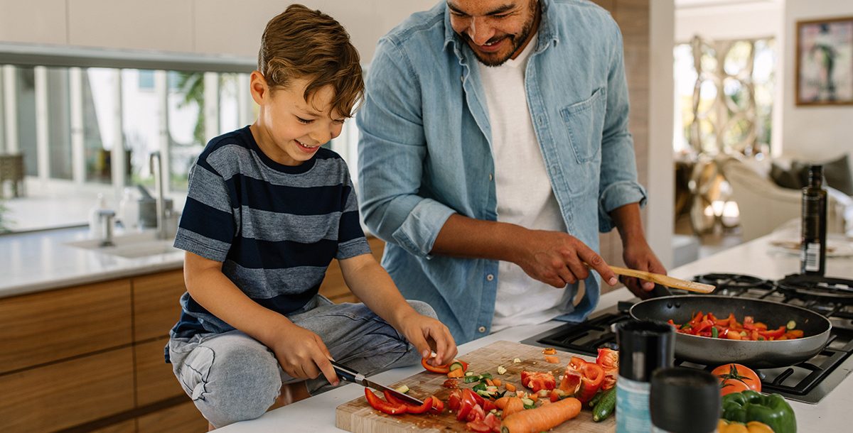 A father and son cooking during the COVID-19 pandemic