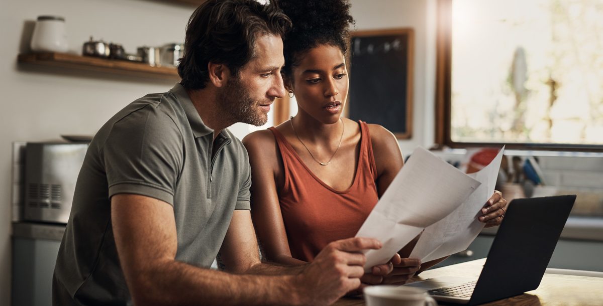 A couple creating a COVID-19 household plan in their kitchen.