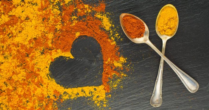 Heart healthy herbs and spices on a counter with spoons.