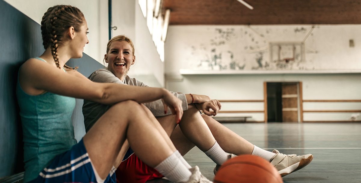 Two student athletes in a gym together.