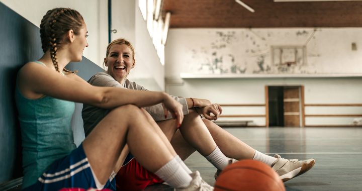 Two student athletes in a gym together.