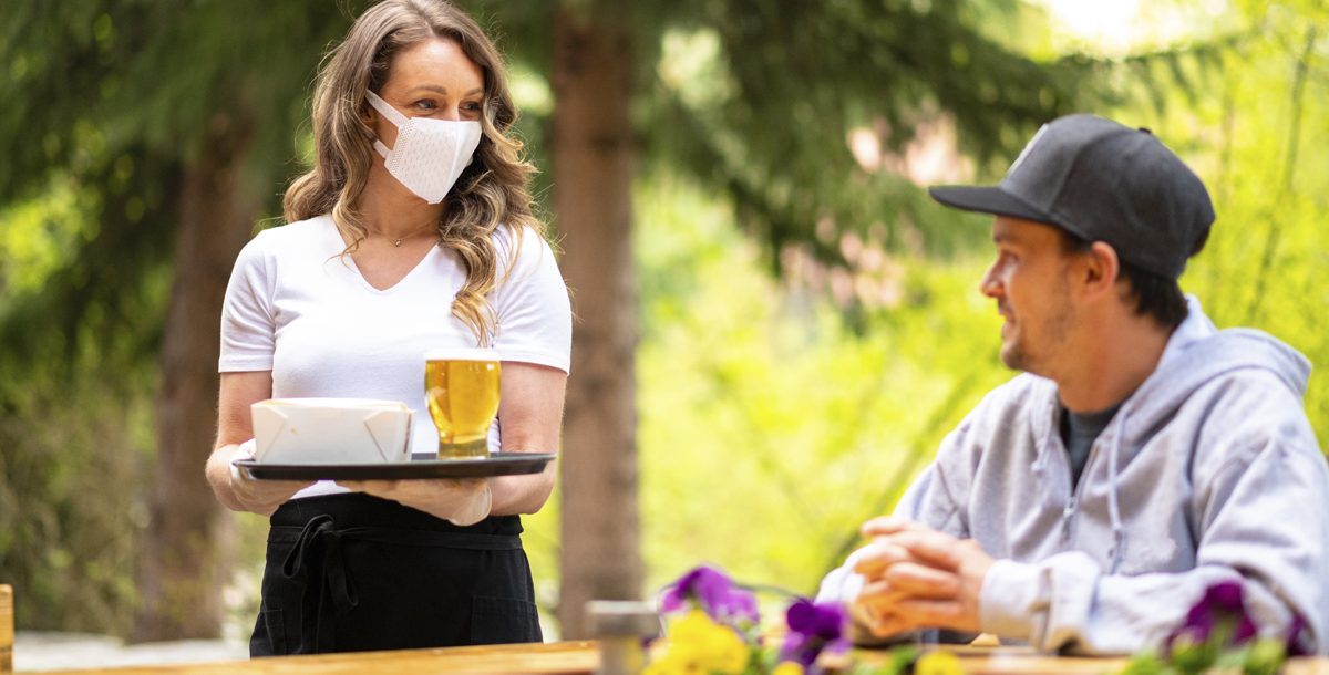 A man dining outside at a restaurant during COVID-19