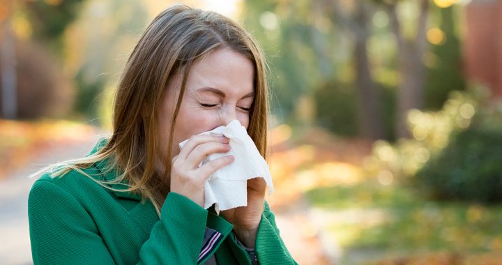 A woman sneezing during COVID-19