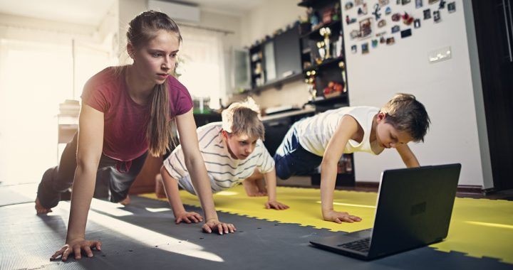 Three children practicing strength training exercises together at home.