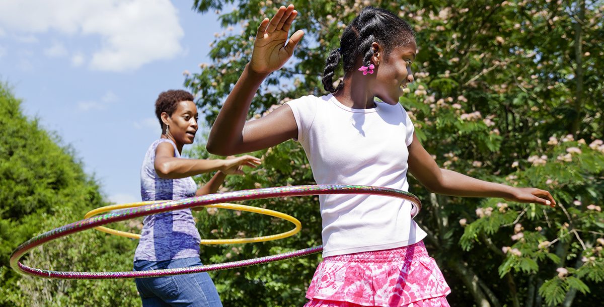 A mother and daughter playing outside together during COVID-19.