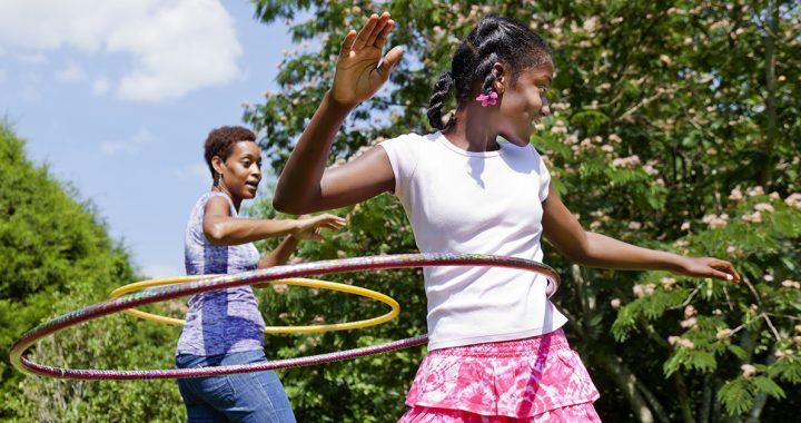 A mother and daughter playing outside together during COVID-19.