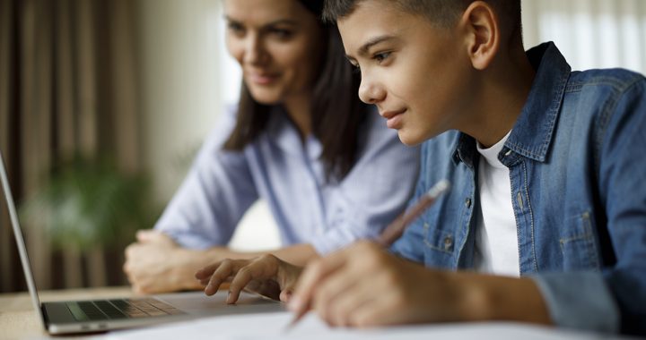 A mother helping her son with e-learning at home during COVID-19.