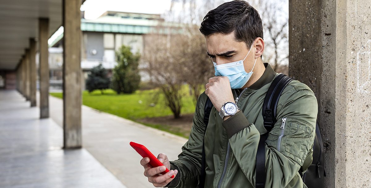 A man getting a contact tracing alert on his smartphone.