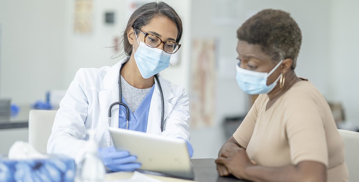 A patient discussing health screenings results with their primary care provider.