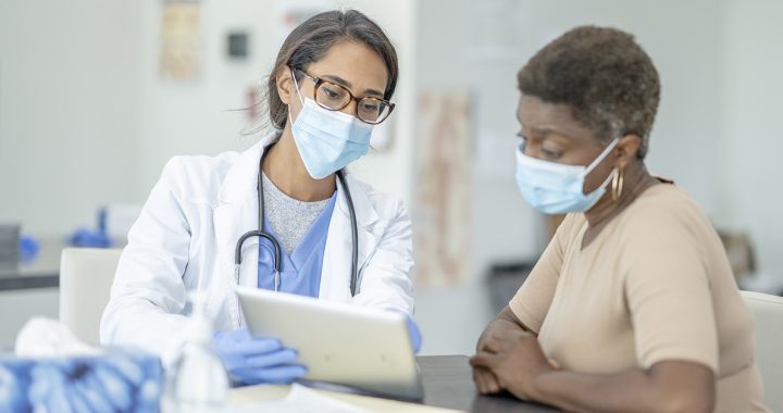 A patient discussing health screenings results with their primary care provider.