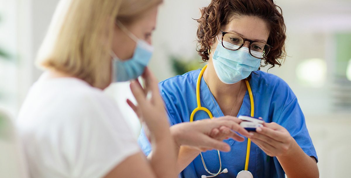 A patient talking with her primary care provider during an appointment.