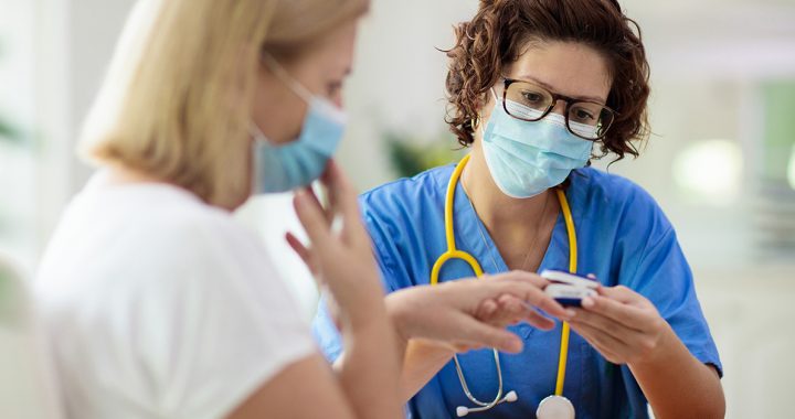 A patient talking with her primary care provider during an appointment.