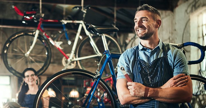 A proud man standing in his garage.