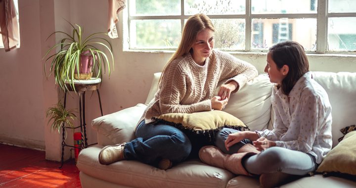 A mother having a serious discussion with her daughter at home.