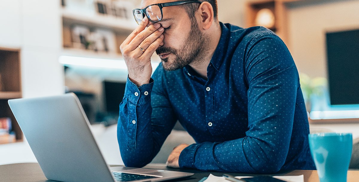 A man experiencing symptoms of burnout.